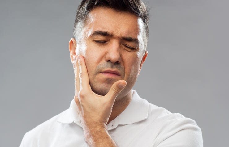 Elderly Guy Suffering from Dental pain | Dental Pain Relief & Treatment in West Liberty, IA, North Liberty, IA and Muscatine, IA | Gentle Family Dentists