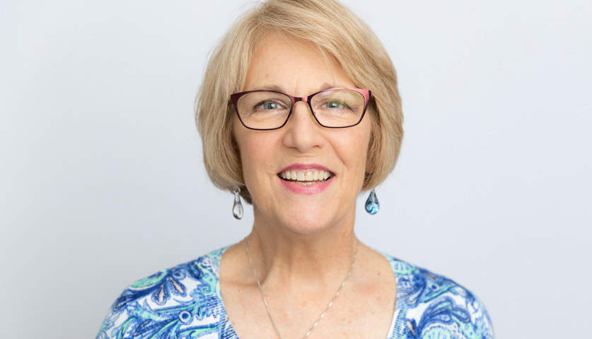 Mature Looking Woman with Eyeglasses Smiling | Dental Implants in West Liberty, IA | Gentle Family Dentists