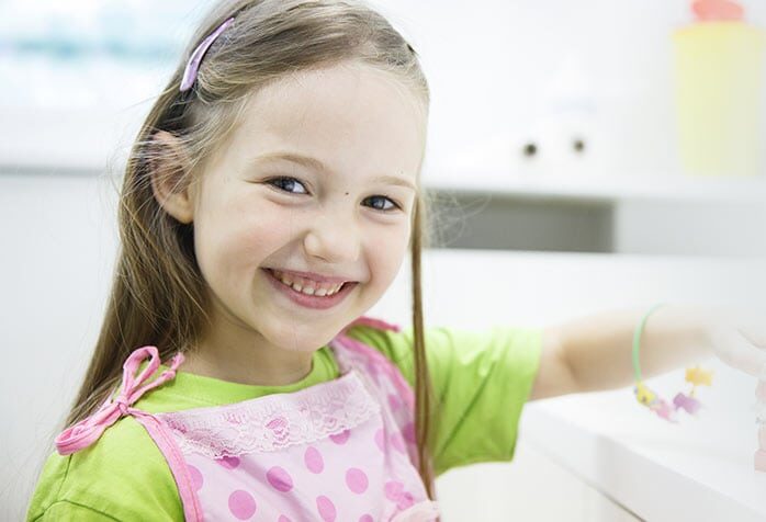 Little Girl Holding the Mock-up of mouth | Tooth Removal/Extraction in West Liberty, IA, North Liberty, IA and Muscatine, IA | Gentle Family Dentists