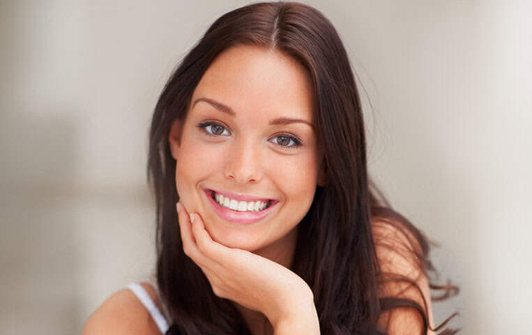 Pretty Woman Sweetly Smiling | Wisdom Teeth Removal in West Liberty, IA | Gentle Family Dentists