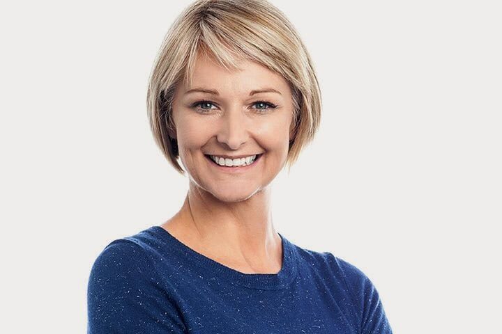 Smiling Lady wearing a blue shirt | Full-Mouth Reconstruction in West Liberty, IA | Gentle Family Dentists