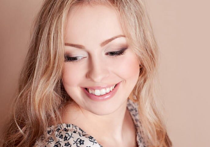 Candid shot of a beautiful lady smiling | Gum Reshaping/Gummy Smile Treatment in West Liberty, IA